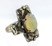 An Art Nouveau opal ring, floral and foliate carved, claw set with an oval-cut opal cabochon, marked
