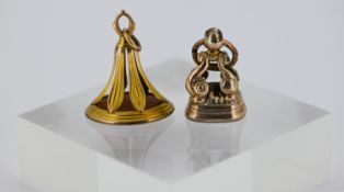 Two antique carnelian seal fobs, including one with a carved family crest and monogram, unmarked
