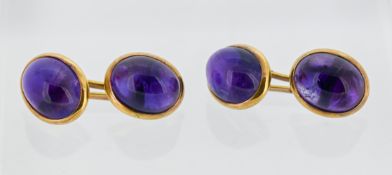 A pair of antique amethyst cufflink's, each face set with an oval-cut amethyst cabochon, marked