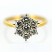 An 18ct gold diamond daisy cluster ring, claw set with seven brilliant-cut diamonds, size O1/2, 3.