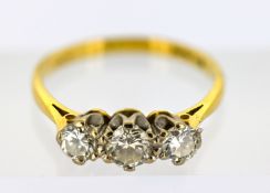 An 18ct gold three stone diamond ring, claw set with three brilliant-cut diamonds, diamonds