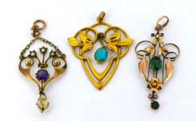 Three Edwardian pendants of varied Art Nouveau design, including an openwork pendant with a