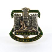 A 9ct gold and enamel Devonshire & Dorset Military cap badge, featuring the Gibraltar castle and key