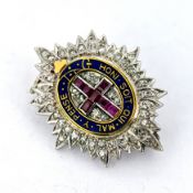 An antique diamond, ruby & enamel Coldstream Guards brooch, in the form of an oval eight point
