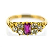 An antique ruby & diamond ring, claw set to the centre with a rectangular-cut ruby,