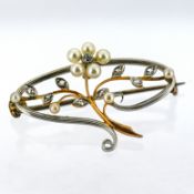 An Edwardian pearl and diamond brooch, an openwork brooch of floral and foliate design set with seed