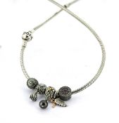 A Pandora necklace with six charms, the Pandora snake chain necklace with six charms including