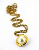 A mabe pearl pendant with chain, the circular pendant set with a mabe pearl, unmarked yellow