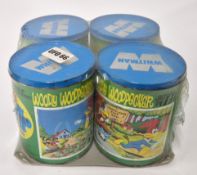 Woody Woodpecker, four Whitman jigsaw puzzles in tins, unopened in plastic wrap.