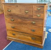 A 19th century chest of drawers, the top left section folding down into a writing desk, elaborate