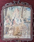 A 19th century woven scene of a mother and children gathering wheat, in a carved wooden frame,