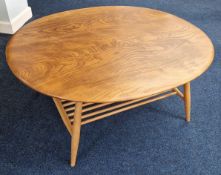 An Ercol oval coffee table with magazine rack, circa 1970s, length approx 99cm.