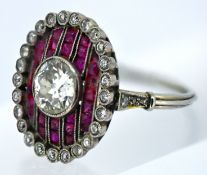 An impressive Art Deco diamond and ruby oval target ring, milgrain bezel set to the centre with an