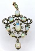 An Edwardian belle epoque opal and diamond pendant, of openwork scrolling form, collet set with