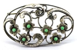 An openwork floral & foliate Arts & Crafts brooch, the flowerheads being centrally set with a pale