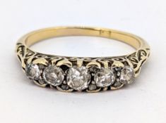 An antique five stone diamond ring, claw set with five graduated old-cut diamonds, each