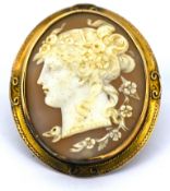 A Victorian cameo brooch, the carved cameo set into an ornate mount, unmarked, metal pin, safety