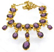 An antique gilt paste stone necklace, the fancy scrolling link necklace claw set with oval-cut