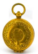 An antique gilt sovereign holder, with carved design to front, diameter approx. 3.2cm, 18.8grams.