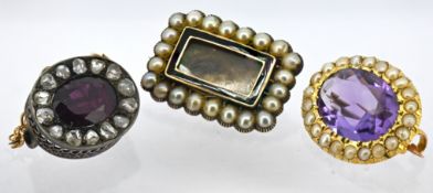 A group of three Victorian brooches, including a Victorian brooch set with an oval-cut garnet and