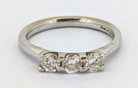 An 18ct gold diamond trilogy ring, claw set with three brilliant-cut diamonds, diamonds approx. 0.66