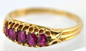 A five stone ruby ring, claw set with five graduated oval-cut rubies, indistinct mark, size M1/2,
