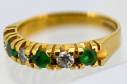 An 18ct gold emerald and diamond six stone ring, claw set with alternating circular-cut emeralds and