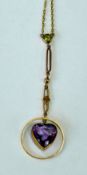 An Edwardian amethyst and peridot necklace, trace chain to the pendant set with a circular-cut