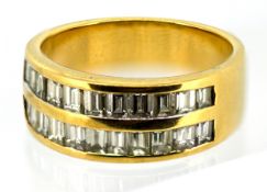 A double row diamond ring, the wide band channel set to the front with two rows of baguette-cut