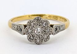 An 18ct gold diamond daisy ring, grain set with old-cut diamonds, hallmarked, size L to L1/2, 2.