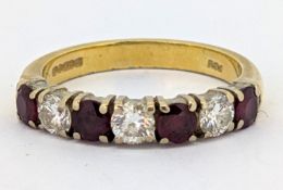 An 18ct gold ruby & diamond seven stone ring, claw set with alternating circular-cut rubies and