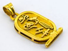 An Egyptian hieroglyph pendant, carved to each side with Egyptian symbols, Egyptian mark to bale,