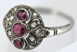An Art Deco ruby & diamond ring, of pierced circular form, milgrain set with a row of three