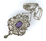 An antique paste stone pendant with chain, the ornate openwork pendant set centrally with a purple