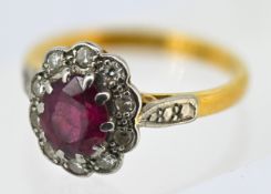 A ruby and diamond cluster ring, claw set to the centre with an oval-cut ruby and a grain set