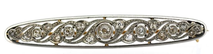 An Edwardian diamond brooch, milgrain and collet set with old-cut diamonds, the central diamond