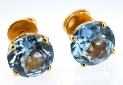 A pair of antique stud earrings, each set with a circular-cut synthetic blue spinel, screw thread
