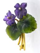 A floral spray brooch, the flowers of carved amethyst, claw set to each centre with a small single-