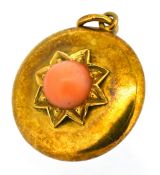 A Victorian coral keepsake pendant, of circular form with applied raised star decoration set with
