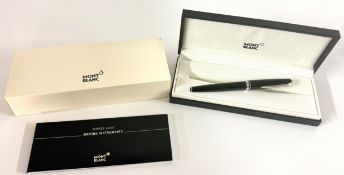 Montblanc, a black resin rollerball pen, with service guide book and box.