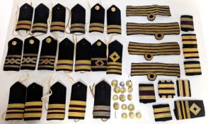 A collection of officer epaulettes and buttons.