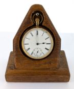 A gold plated pocket watch with roman dial, accompanied with wooden mount.