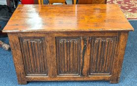An oak blanket chest with linen fold design, with label James Phillips & Sons Ltd., Bristol,
