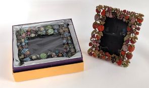 A pair of Butler & Wilson frames with decorative berries and foliage, one in box