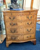 A reproduction mahogany serpentine chest, fitted with four drawers, a brushing slide on bracket feet