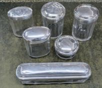 A collection of various silver and glass dressing table jars. (6)