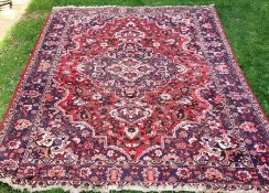 A hand-knotted Persian rug, with label inscribed HS, width approx. 208cm.
