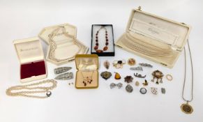 A group of costume jewellery, including necklaces and brooches.