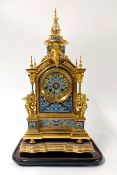 A 19th century French gilded and champleve enamelled clock with glass dome, the dial inscribed