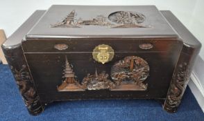 A 20th century Chinese camphor wood chest, with pagoda and rowing imagery